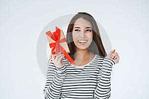 Portrait of young happy asian woman with gift box in hands on white background isolated