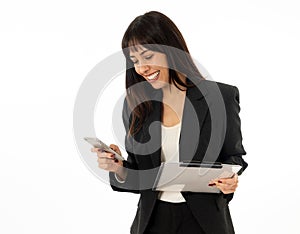 Portrait of a young happy attractive business woman checking emails and texting on mobile phone