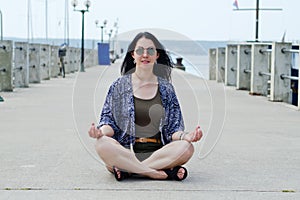 Portrait of young happy brunette woman in sunglasses relaxing at the seaside, beach at Adriatic sea. Summer vacation. Travel