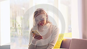 Portrait of young happy business woman enjoy success on mobile phone at home office. Joyful girl reading good news on phone. Surpr