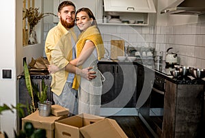 Portrait of young happy couple moving in new home