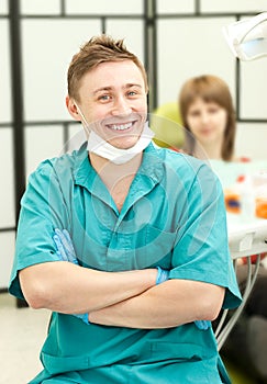 Portrait of young happy dentist in his surgery