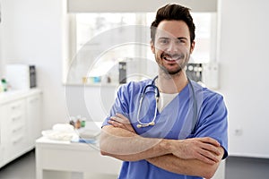 Portrait of young happy doctor in the doctor\'s office