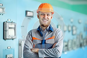 Portrait of young happy engineer at control room