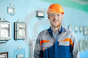Portrait of young happy engineer in control room