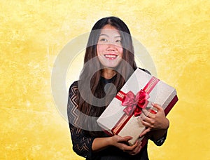 portrait of young happy and excited beautiful Asian Chinese woman receiving a romantic anniversary gift box holding the