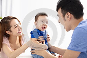 Portrait of young happy family with baby