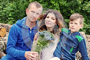 Portrait of a young happy family outdoors