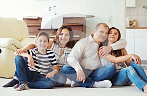 Portrait of young happy family with pretty teenager daughter and