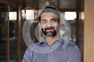 Portrait of young happy indian business man executive looking at camera.