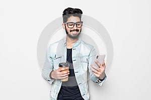 Portrait of young happy Indian man making video call from the phone isolated on white background