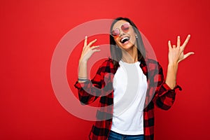 Portrait of young happy positive beautiful brunette woman with sincere emotions wearing white t-shirt, stylish red check