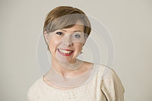 Portrait of young happy and pretty red hair woman on her 30s in sweet smile and positive face expression looking to camera isolate