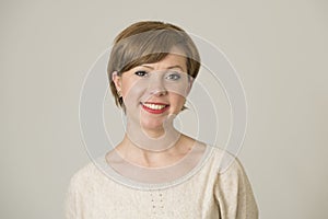 Portrait of young happy and pretty red hair woman on her 30s in sweet smile and positive face expression looking to camera isolate