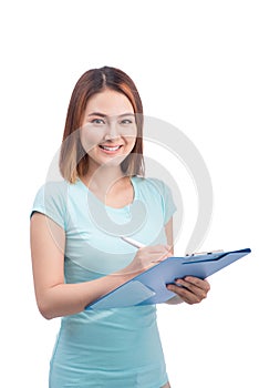 Portrait of young happy smiling asian woman writting on blue fol