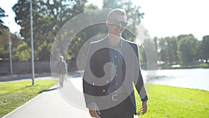 Portrait of young happy smiling cheerful businessman walking home after successful day at work, job interview or a