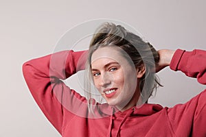 Portrait of young happy smiling woman with colourful hair posing in the studio.