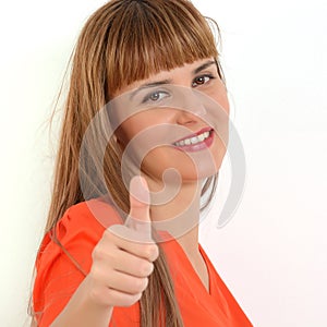 Portrait of young happy smiling woman showing thumbs up gesture