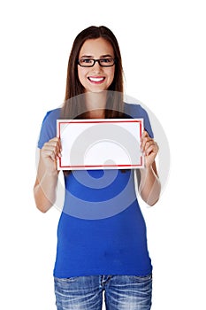 Portrait young happy woman with blank board