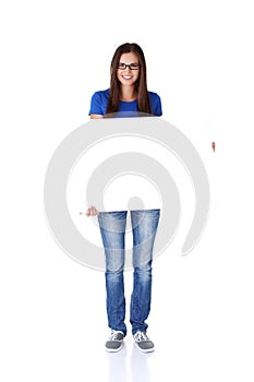 Portrait young happy woman with blank board