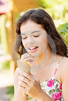 Portrait of young happy woman eating ice-cream