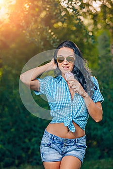 Portrait of young happy woman eating ice cream