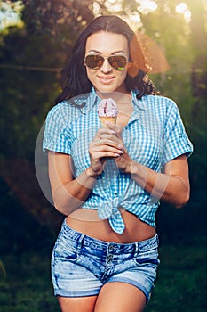 Portrait of young happy woman eating ice cream