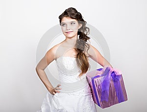 Portrait of young happy woman with gift box in hands