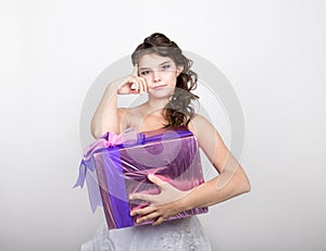 Portrait of young happy woman with gift box in hands