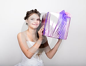 Portrait of young happy woman with gift box in hands