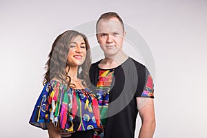Portrait of young healthy sporty dancers couple hugging on white background.