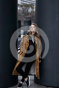 Portrait of young hipster girl in black jeans and hoodie