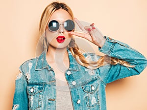 Portrait of young hipster girl posing in studio