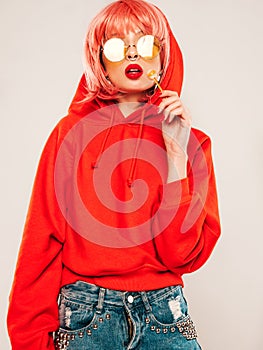 Portrait of young hipster girl posing in studio