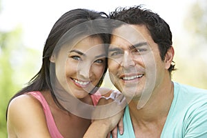 Portrait Of Young Hispanic Couple In Park