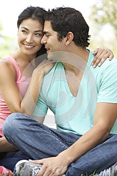 Portrait Of Young Hispanic Couple In Park