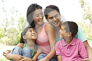 Portrait Of Young Hispanic Family In Park