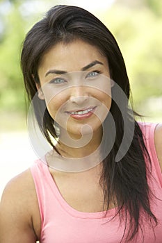 Portrait Of Young Hispanic Woman In Park