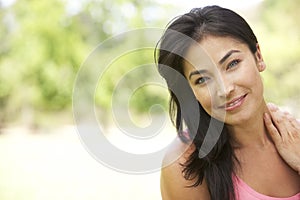 Portrait Of Young Hispanic Woman In Park