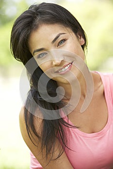 Portrait Of Young Hispanic Woman In Park