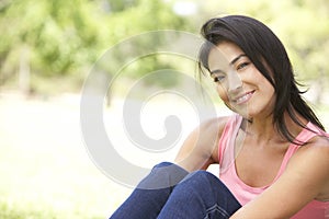 Portrait Of Young Hispanic Woman In Park