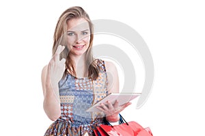 Portrait of young hopeful shopper holding fingers crossed