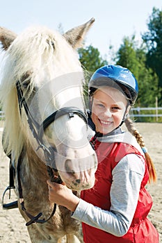 Portrait of young horsewoman and brown horse.