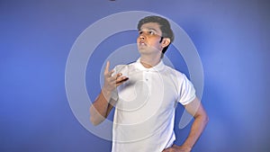 Portrait of young Indian sportsman playing with a leather ball before the cricket practice session