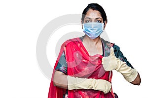 Portrait of young Indian woman wearing mask for protect Coronavirus / covid-19, wearing gloves demonstrating thumbs-up isolated on