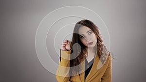 Portrait of young irritated woman making bla bla sign by her hand on white background in a slowmo