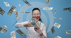 Portrait of young joyful business woman enjoying money cash fan