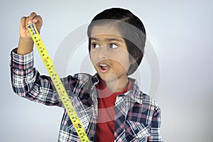 Portrait of young kid measuring height