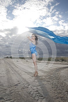 Portrait of young lady with long blue material