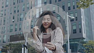 Portrait of young lady making selfie in business district of town. Woman takes a photo during working trip, having fun